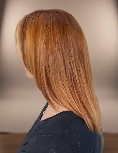 A person with straight, shoulder-length, light brown hair, seen from the side, wearing a dark top.